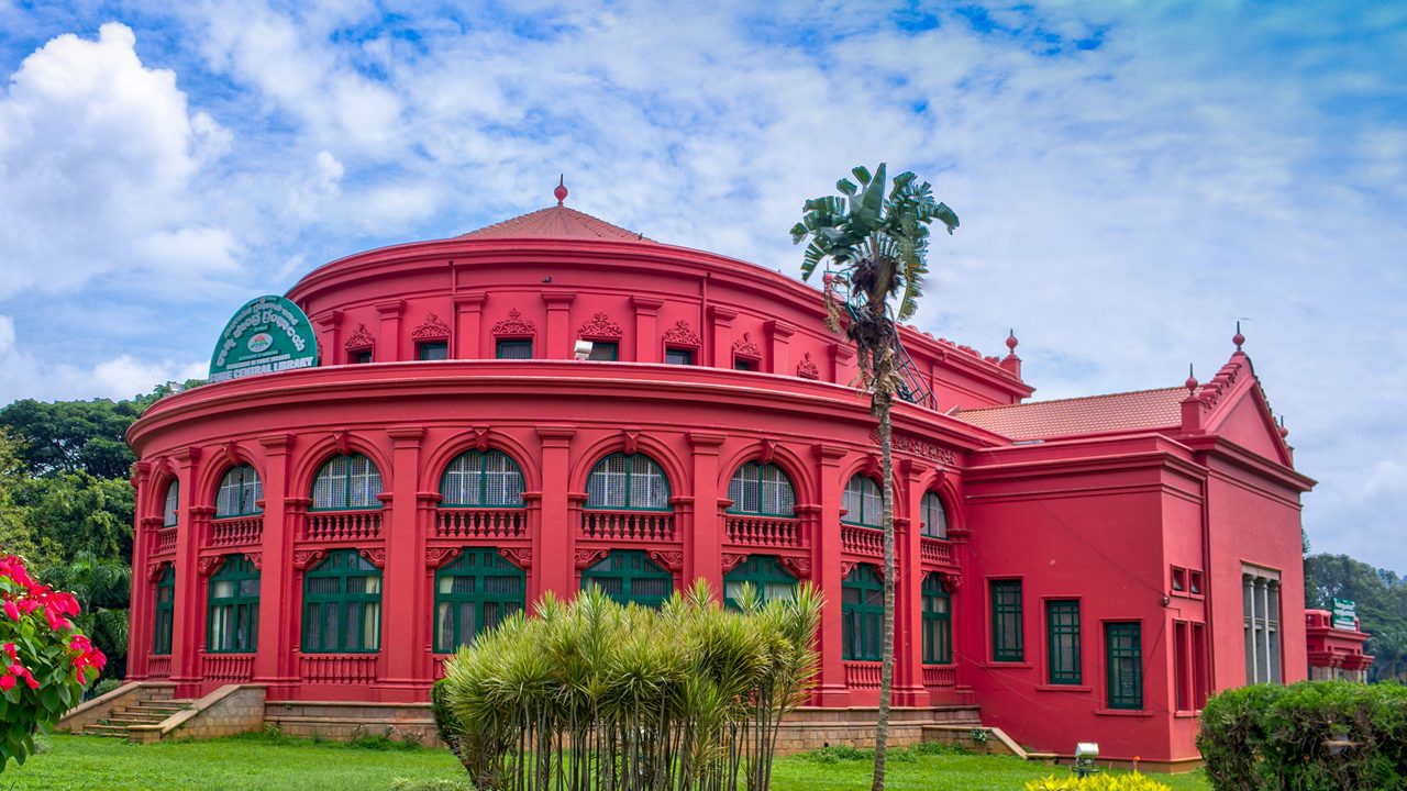 Heritage Building in Bangalore, India. This is State Central Library. Te sign board says "State Central Library" in Kannada Language and English. 