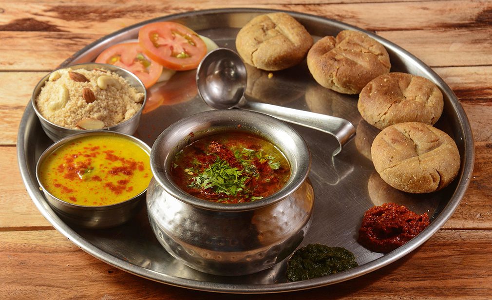 Rajasthani Traditional Cuisine Dal Baati Also Know as Dal Bati or Daal Baati Churma on Wooden Background. selective focus