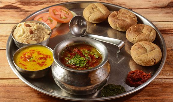 Rajasthani Traditional Cuisine Dal Baati Also Know as Dal Bati or Daal Baati Churma on Wooden Background. selective focus