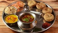 Rajasthani Traditional Cuisine Dal Baati Also Know as Dal Bati or Daal Baati Churma on Wooden Background. selective focus