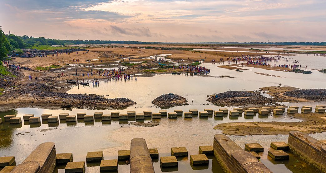 View of Durgapur Barrage and  Indian Hindu people doing "Tarpan", a  Faithfuls offer  to the divine for the liberation of the soul of their deceased elders .