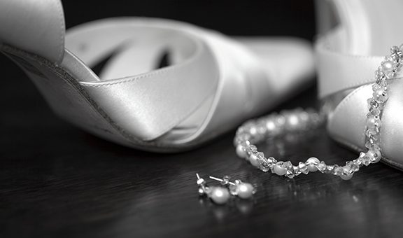 Wedding shoes and jewellery taken in black and white