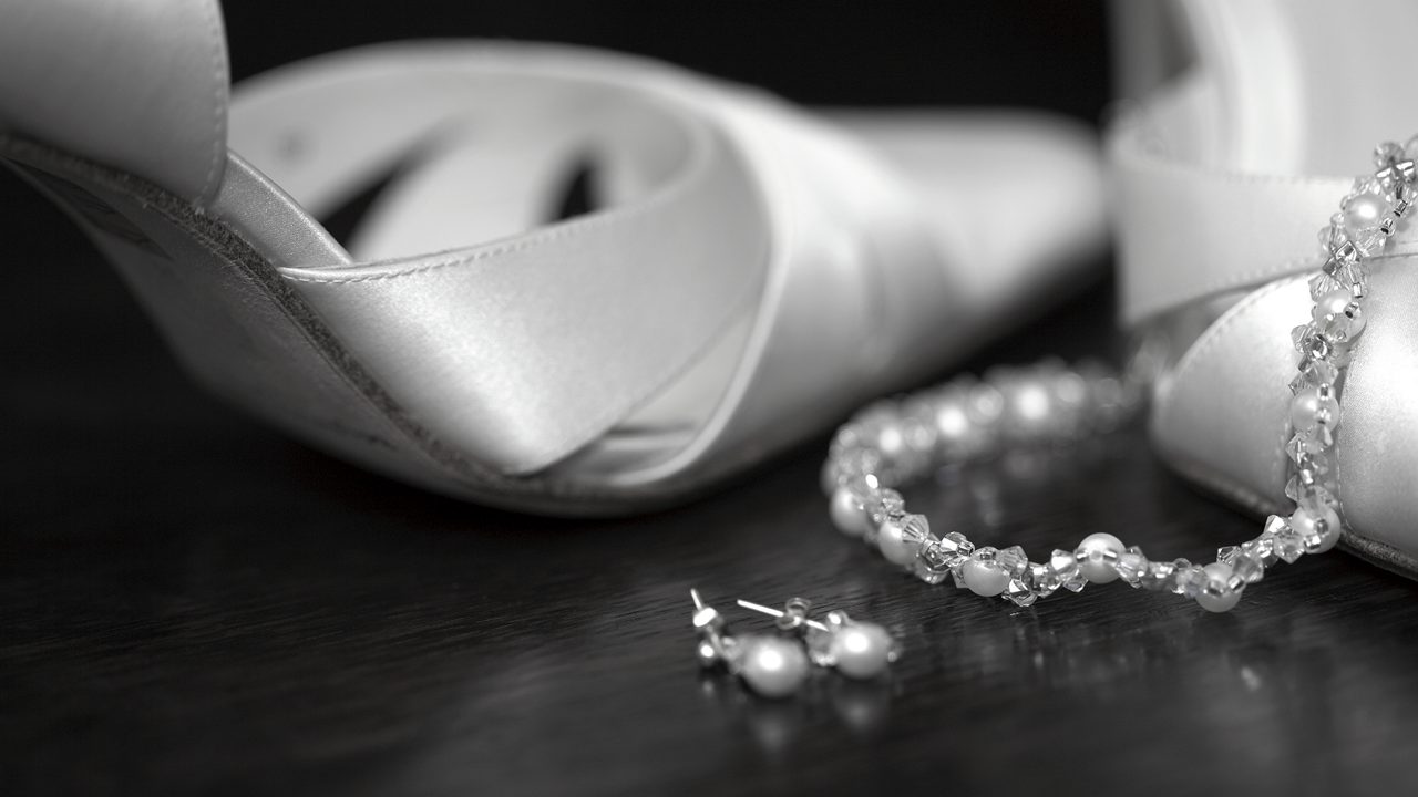 Wedding shoes and jewellery taken in black and white
