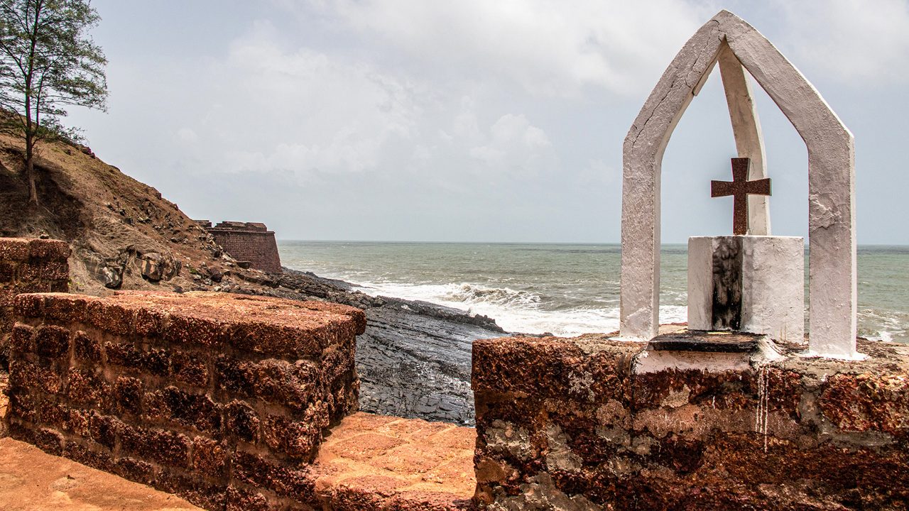 Catholic old cross on a brick wall of Fort Aguada, the coast of Arabian Sea in Goa; Shutterstock ID 1564650595; purchase_order: -; job: -; client: -; other: -