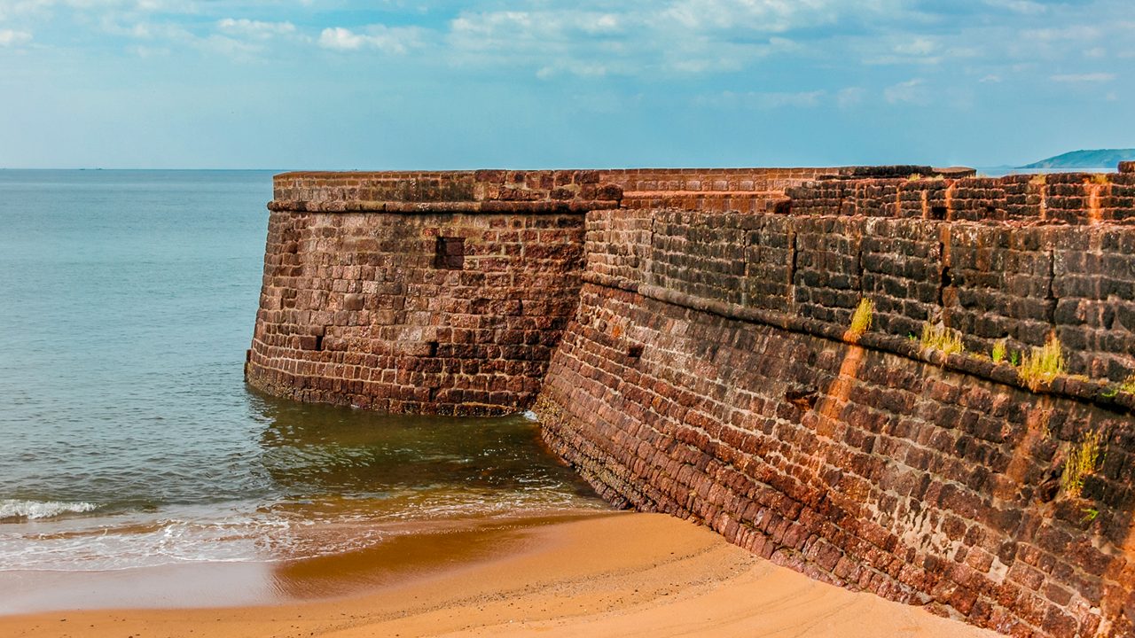 Aguada Fort. Ancient fortress on the shores of the Indian ocean. Goa. India. Vacation holidays travel background wallpaper; Shutterstock ID 1037331364; purchase_order: -; job: -; client: -; other: -