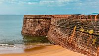 Aguada Fort. Ancient fortress on the shores of the Indian ocean. Goa. India. Vacation holidays travel background wallpaper; Shutterstock ID 1037331364; purchase_order: -; job: -; client: -; other: -