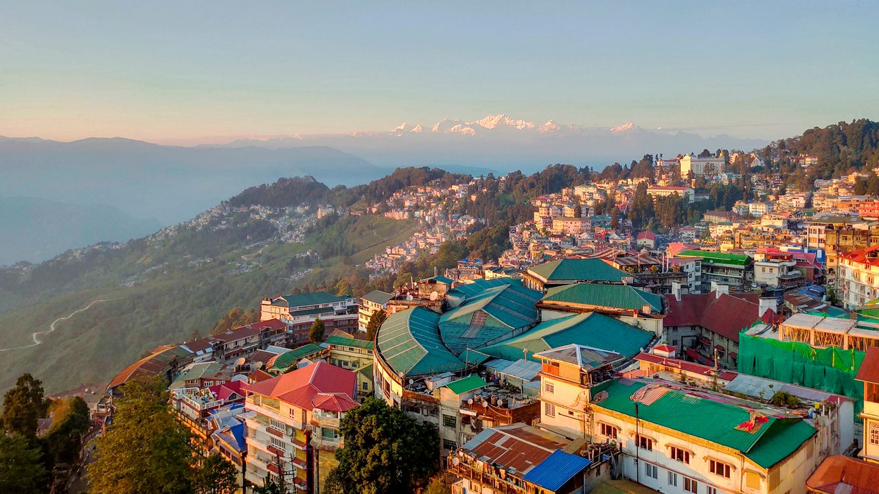 The beautiful Gangtok City from the Rope-way with a background of golden color Kangchenjunga and blue sky