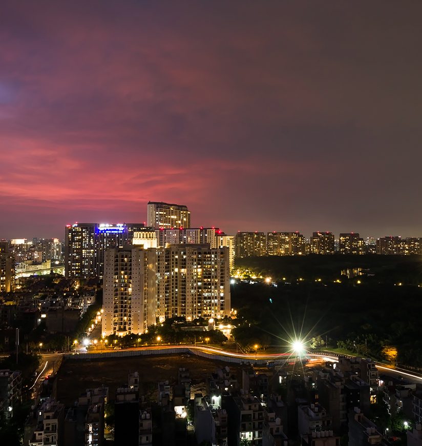 Sunset in Gurgaon,Haryana,India residential apartments, commercial hub skyline during monsoon, pandemic.Urban cityscape,lights trails at night on July 20,2021.Delhi NCR's posh business locality.