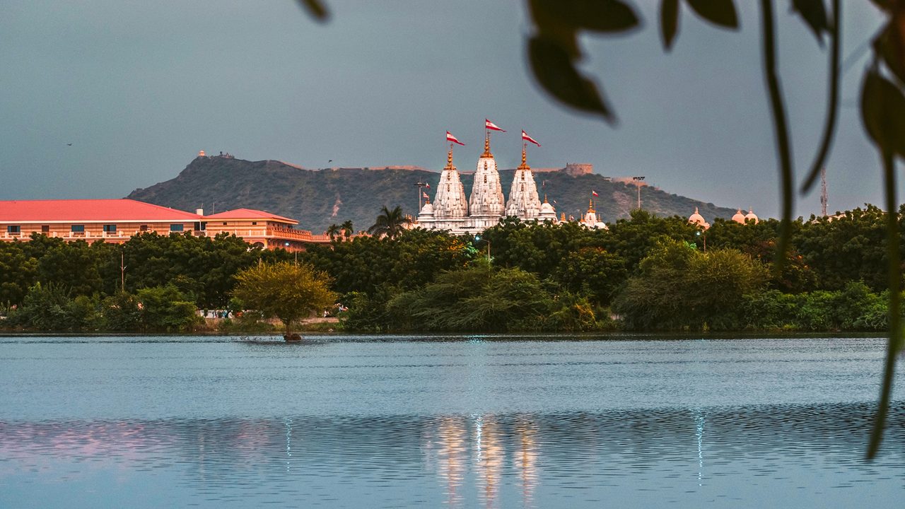 Scenic view of Hamirsar lake with Swaminarayan temple and Bhujya hill in background at Bhuj, Kutch, India