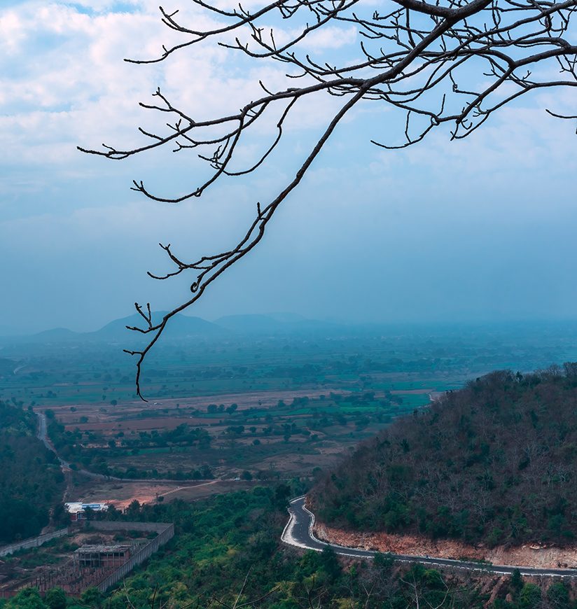 Beautiful mountain landscape of Devangana Valley with mountains, beautiful curving road, foggy green forest, blue sky, located in Vindhya range, Bundelkhand region in Chitrakoot district of UP, India