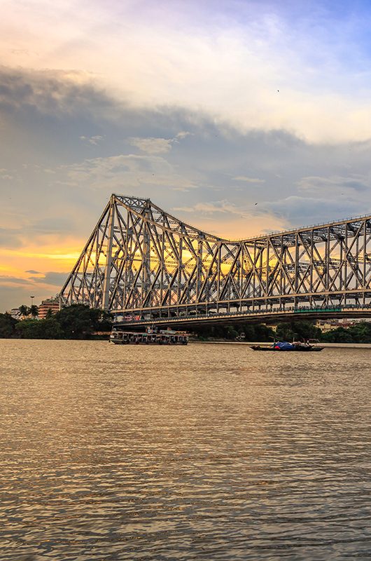 Historic Howrah bridge - The cantilever bridge on river Hooghly at sunset with moody sky.; Shutterstock ID 703393621; purchase_order: -; job: -; client: -; other: -