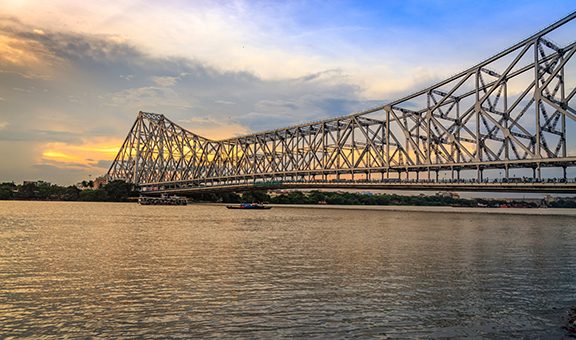 Historic Howrah bridge - The cantilever bridge on river Hooghly at sunset with moody sky.; Shutterstock ID 703393621; purchase_order: -; job: -; client: -; other: -