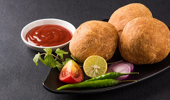 Kachori is a spicy snack from India also spelled as kachauri and kachodi. Served with tomato ketchup. Favourite Tea time snacks Selective focus