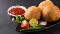 Kachori is a spicy snack from India also spelled as kachauri and kachodi. Served with tomato ketchup. Favourite Tea time snacks Selective focus