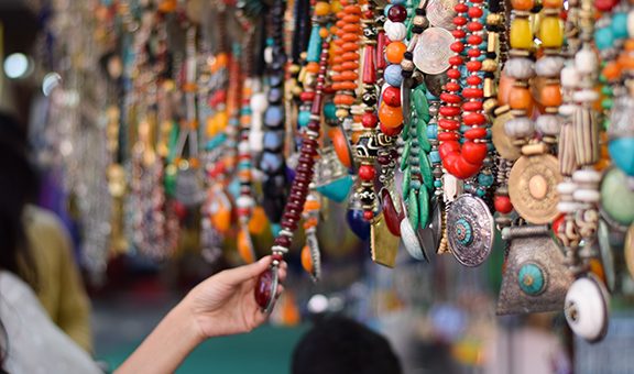 Girl Buying Indian Traditional Handmade Jewellery in Delhi Haat INA Market. This market is famous among the foreign tourist for traditional Indian souvenirs  