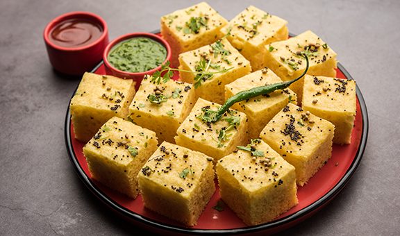 Gujarati Khaman Dhokla made using Chana Dal, served with Green chutney, selective focus