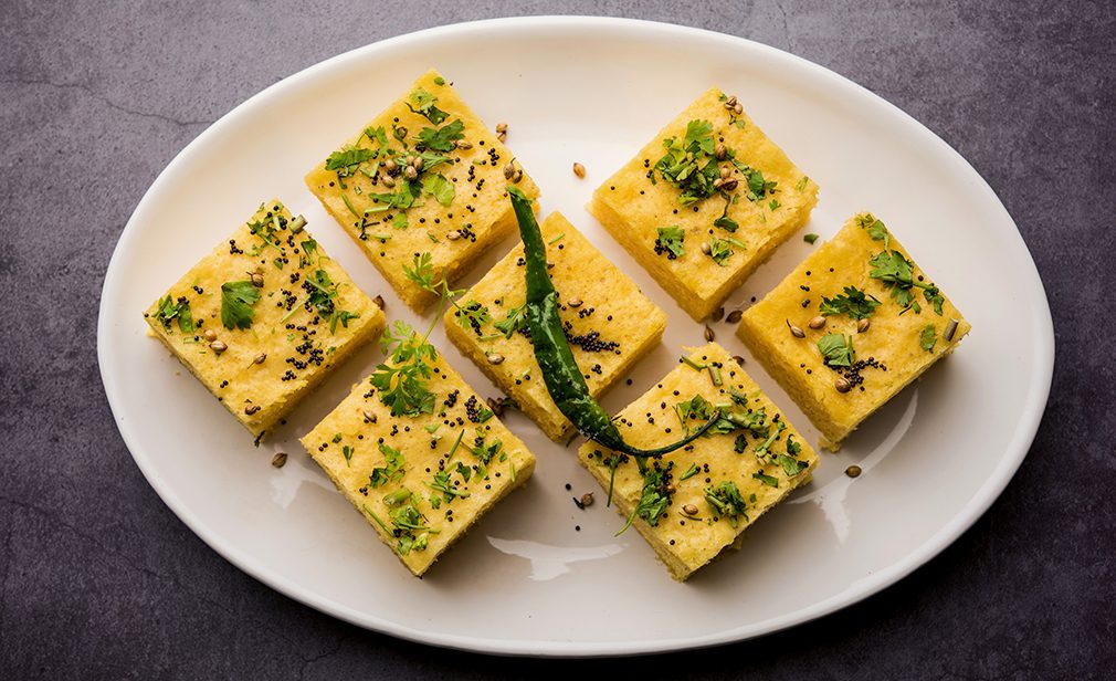 Gujarati Khaman Dhokla made using Chana Dal, served with Green chutney, selective focus