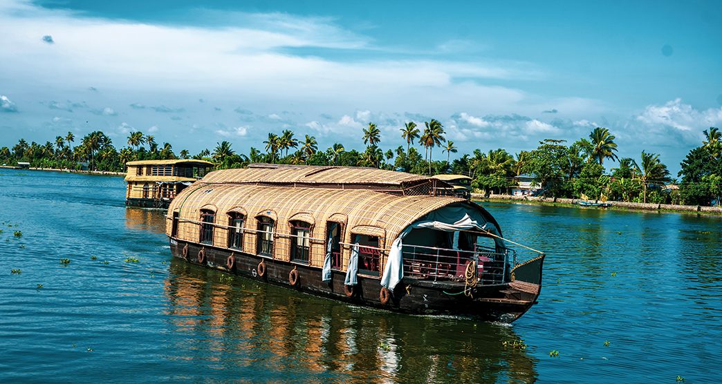 Houseboats on a sunny day in beautiful lake Vembanad kayal  in Alappuzha, Kerala, India.