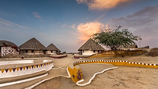 KUTCH, GUJARAT, INDIA: traditional mud huts with thatched roof and painted decoration, called Bhunga