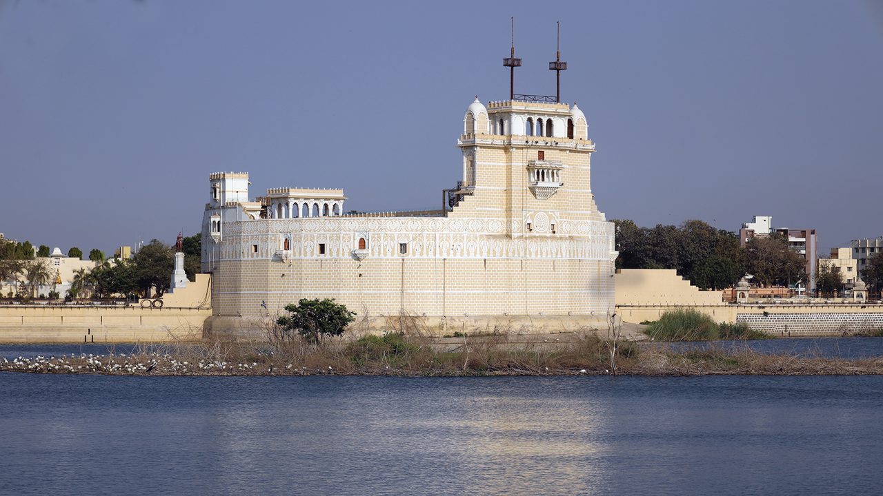 Beautiful Palace in middle of the lakhota lake Jamnagar India with white stone shine and water, Palace stock image