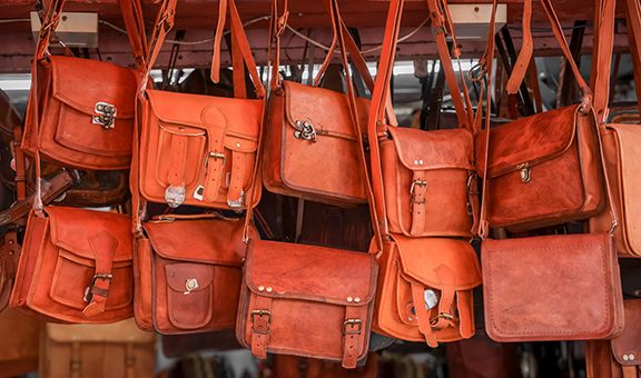 Close up view of several leather hand bags up for sale in street market , Jaipur, India.