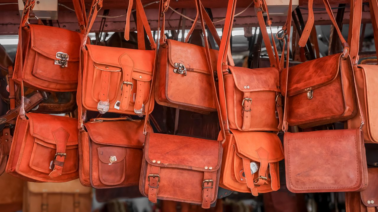 Close up view of several leather hand bags up for sale in street market , Jaipur, India.