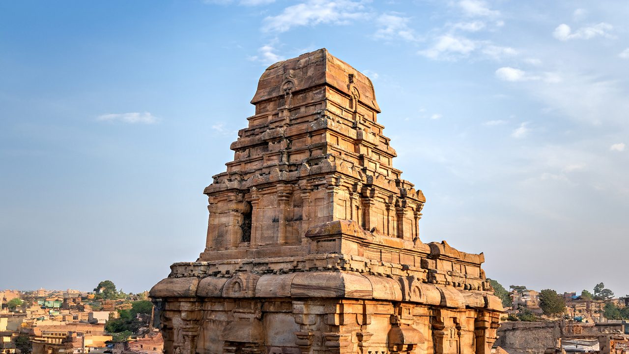 Monkey sitting on ancient stone carved temple in Badami fort, Karnataka,India.