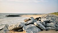 A Scenic View of a Maravanthe Beach in Karnataka with Granite boulders seen during Evening Sunset