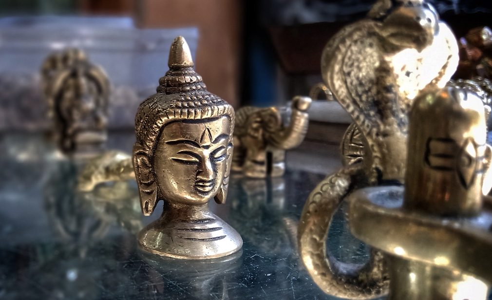 Beautiful brass made face of Buddha is being sold on the souvenir shop in Varanasi, India. Brass made face of Buddha while doing meditation.