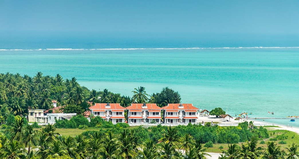 Holiday village on Minicoy tropical island, Lakshadweep with turquoise sea and blue sky