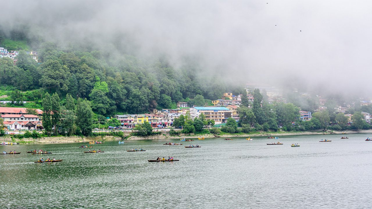 A beautiful landscape of Naini Lake in foggy weather in Nainital, India.