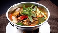 Sour and Spicy Smoked Dry Fish Soup in hot pot, isolated