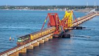 Rameshwaram to Chennai Boat Mail express train crosses 2 kilometers long Pamban sea railway bridge, India.