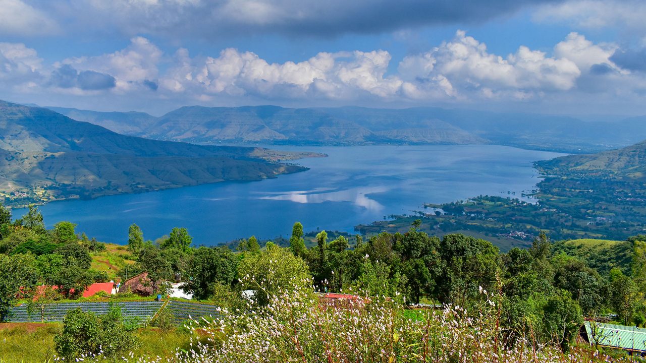 A Beautiful tourist destination, a valley with blue water river / lake, green hill / mountain on backdrop and blue sky. swituated in Panchgani , mahabaleshwar, Maharashtra