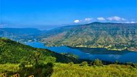 A Beautiful tourist destination, a valley with blue water river / lake, green hill / mountain on backdrop and blue sky. swituated in Panchgani mahabaleshwar, Maharashtra