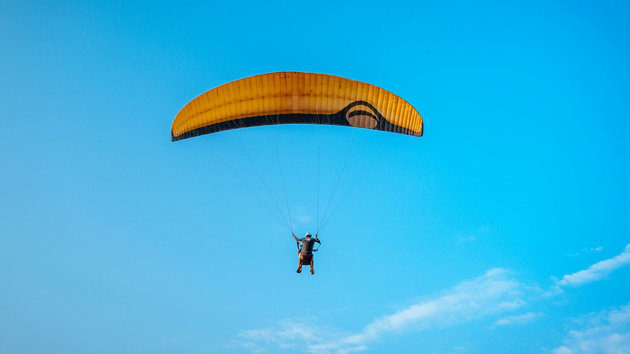 Paraglider in the blue sky in India.