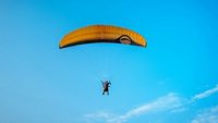Paraglider in the blue sky in India.