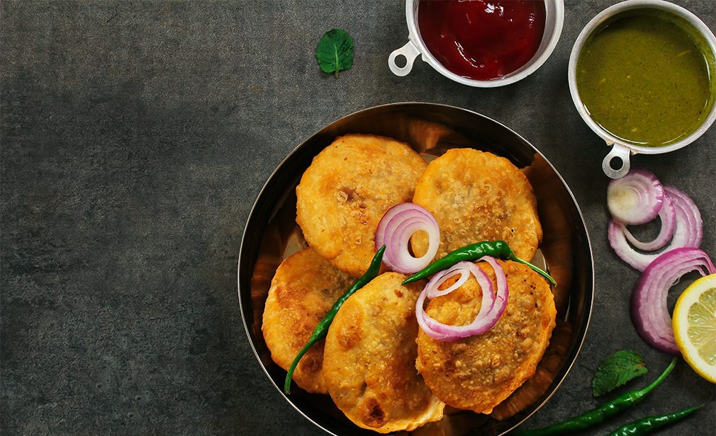 Rajasthani Kachori served with green Chutney / Indian Diwali snacks overhead view