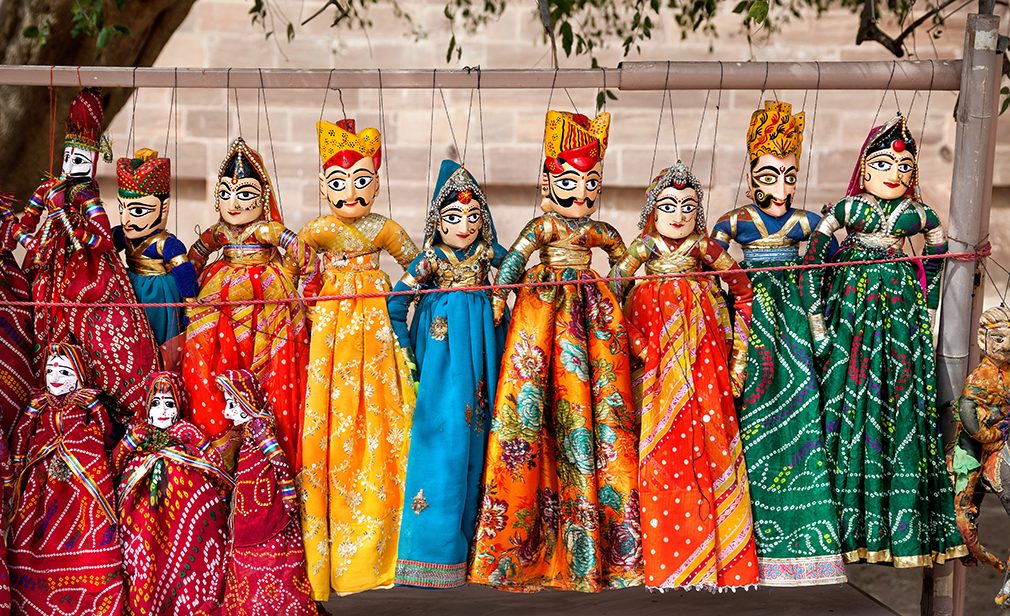 Colorful Rajasthan puppets hanging in the shop of Jodhpur City Palace, India   