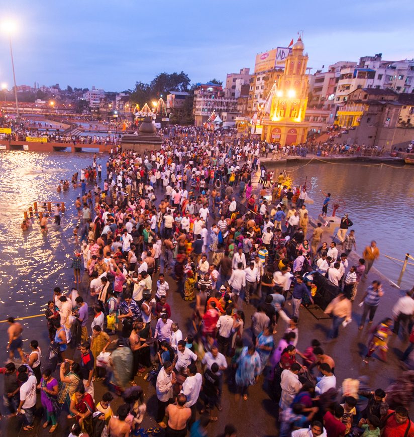 NASHIK, INDIA  29 AUGUST 2015 : Unidentified devotees take a holy bath at the Ramghat on the Godavari River during the Simhastha Kumbh Mela, Nashik, Maharashtra, India.