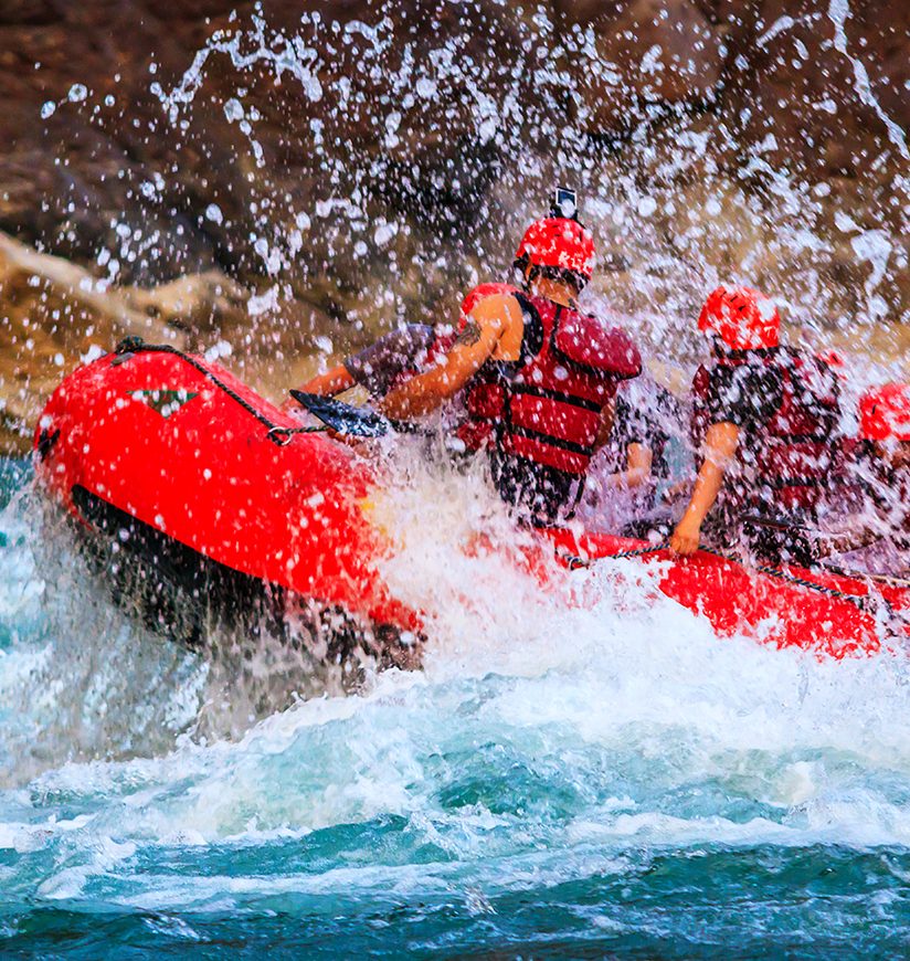 Young person rafting on the river Ganges in Rishikesh, extreme and fun sport at tourist attraction