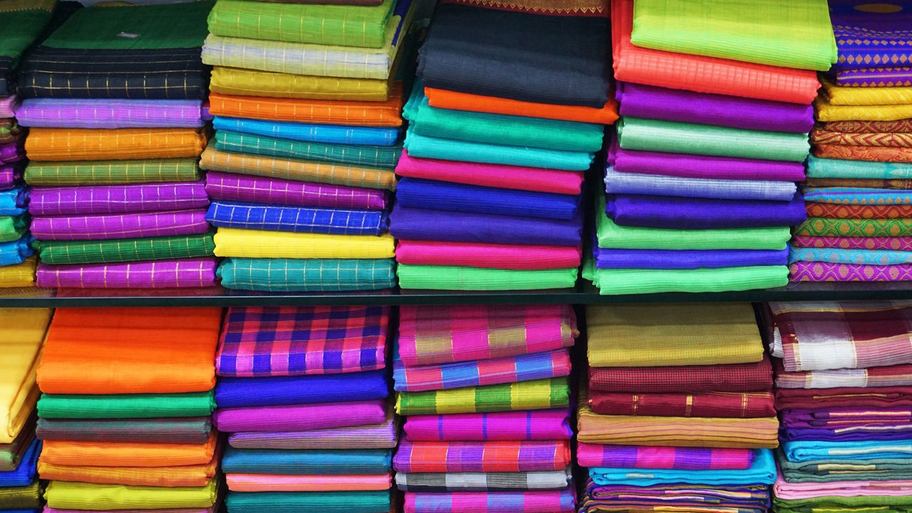 Colorful Managalagiri cotton saris on racks in a textile shop. Incredible India.                                  