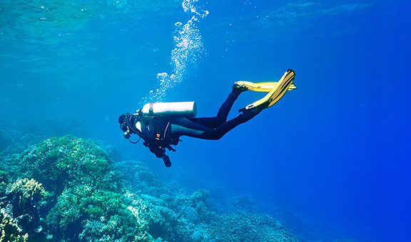 Female scuba diver swimming under water