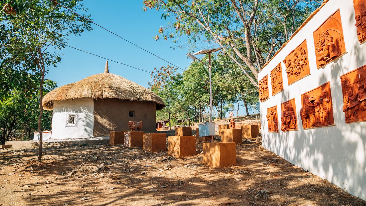 Udaipur, India - December 12, 2017 : Indian folk village Shilpgram, traditional house and sculpture