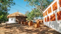 Udaipur, India - December 12, 2017 : Indian folk village Shilpgram, traditional house and sculpture