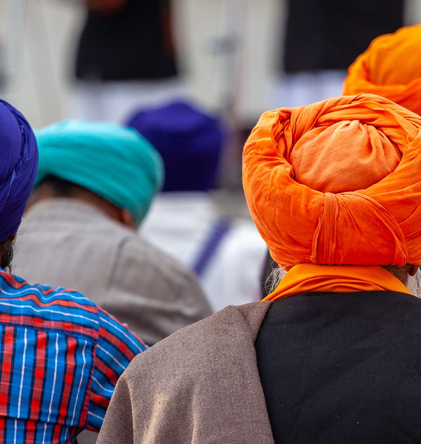 Panoramic of Sikh people from the back with their colory turban at the golden temple in amritsar, India