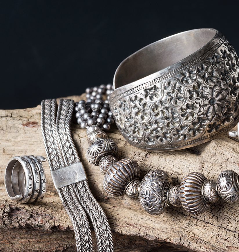 Still life photography : Collection of antique traditional silver jewelry on old wood