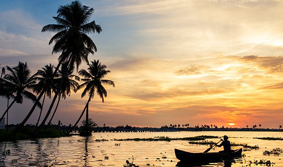 a beautiful Sunset at kerala allapey beach with blueish red sky boat