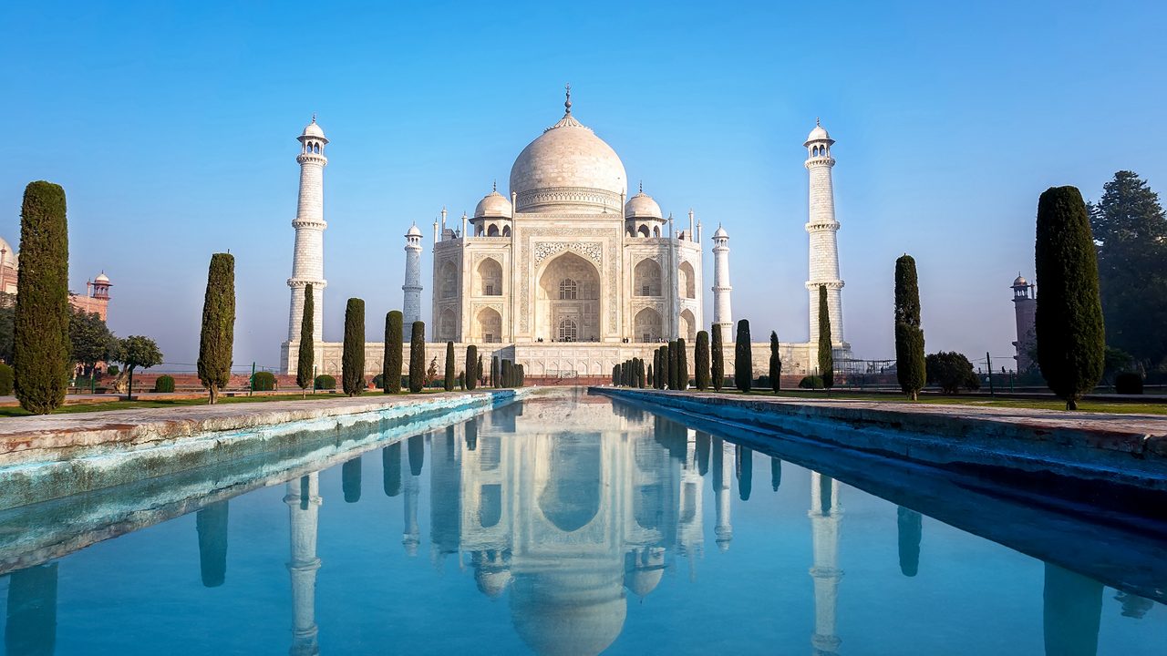 Agra, Uttar Pradesh, India - The morning view of Taj Mahal monument reflecting in water of the pool, Agra, India