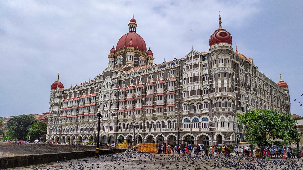 Mumbai, Maharashtra, India - August 11, 2019; The Taj Mahal Palace Hotel is a five-star luxury hotel located near Gateway of India Where lots of tourists are wandering and countless flocks of pigeons are sitting. Resorts & Palaces.